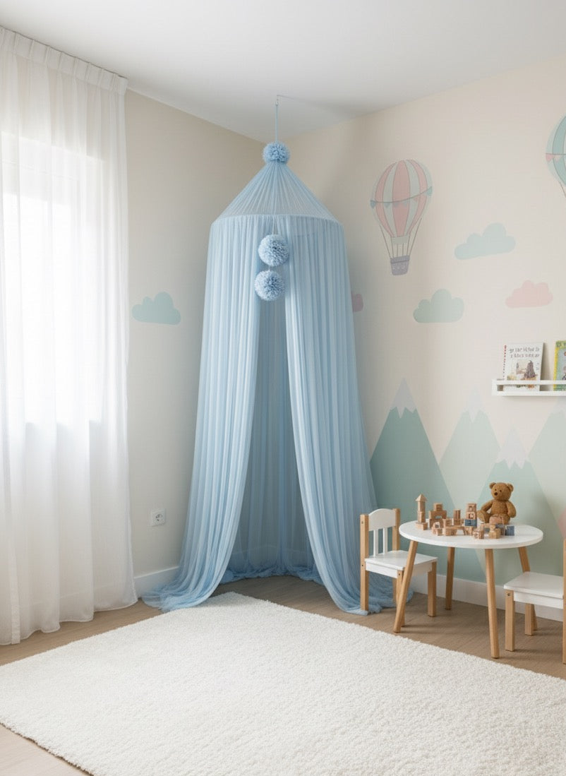 Children's room with a blue canopy, toy table, and teddy bear.