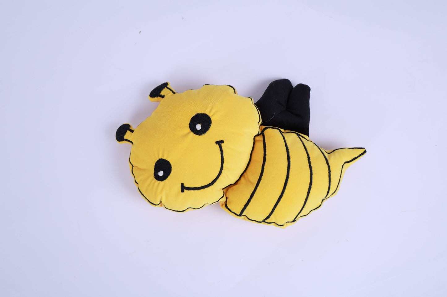 Plush bee toy on a white background