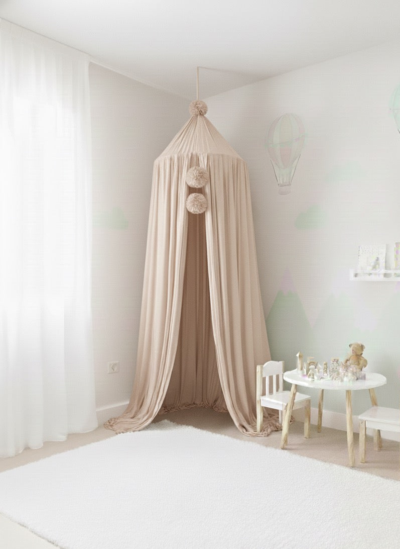Beige canopy in a child's room with white walls and furniture.