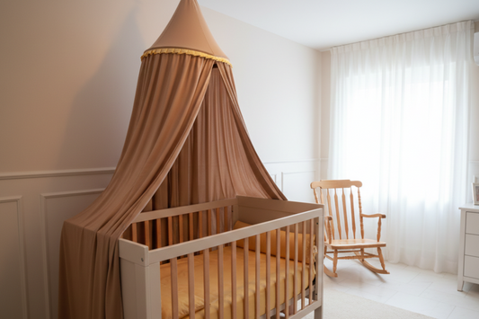 Nursery room with a crib draped with a brown canopy, rocking chair, and dresser.