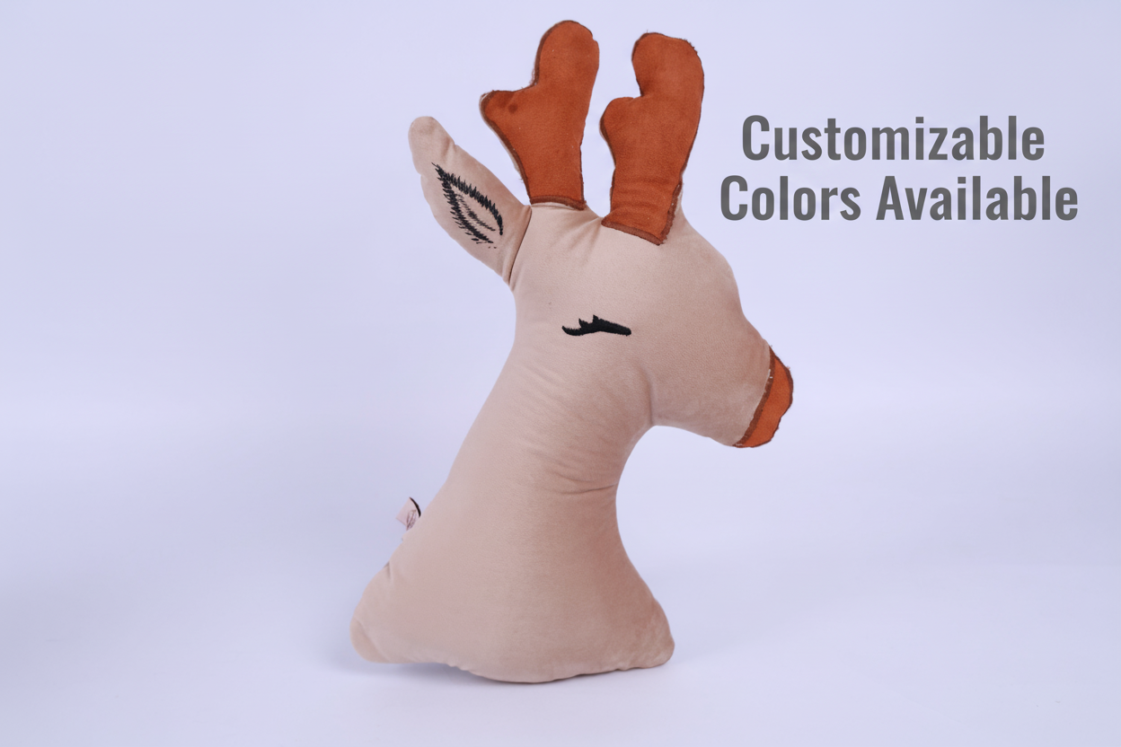 Plush deer head pillow on a light purple background