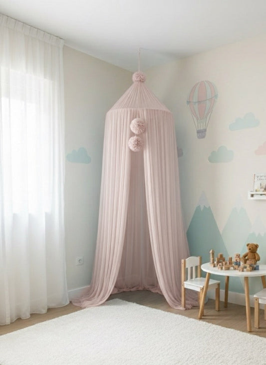 Pink canopy in a child's room with toys and furniture.