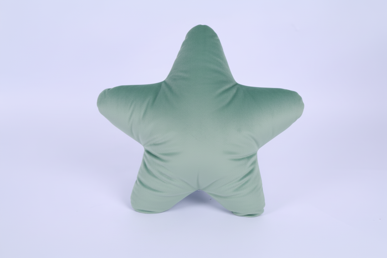 Green star-shaped pillow with facial features on a light purple background
